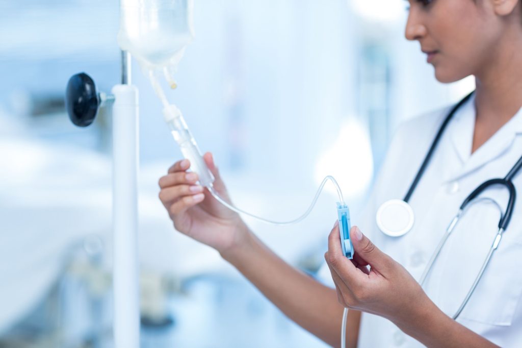 A nurse with an IV fluid bag