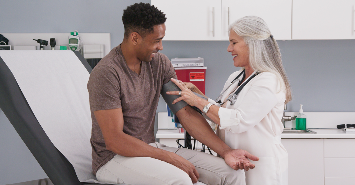 An older doctor treating a patient