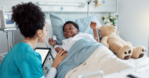 a child smiling in a hospital bed
